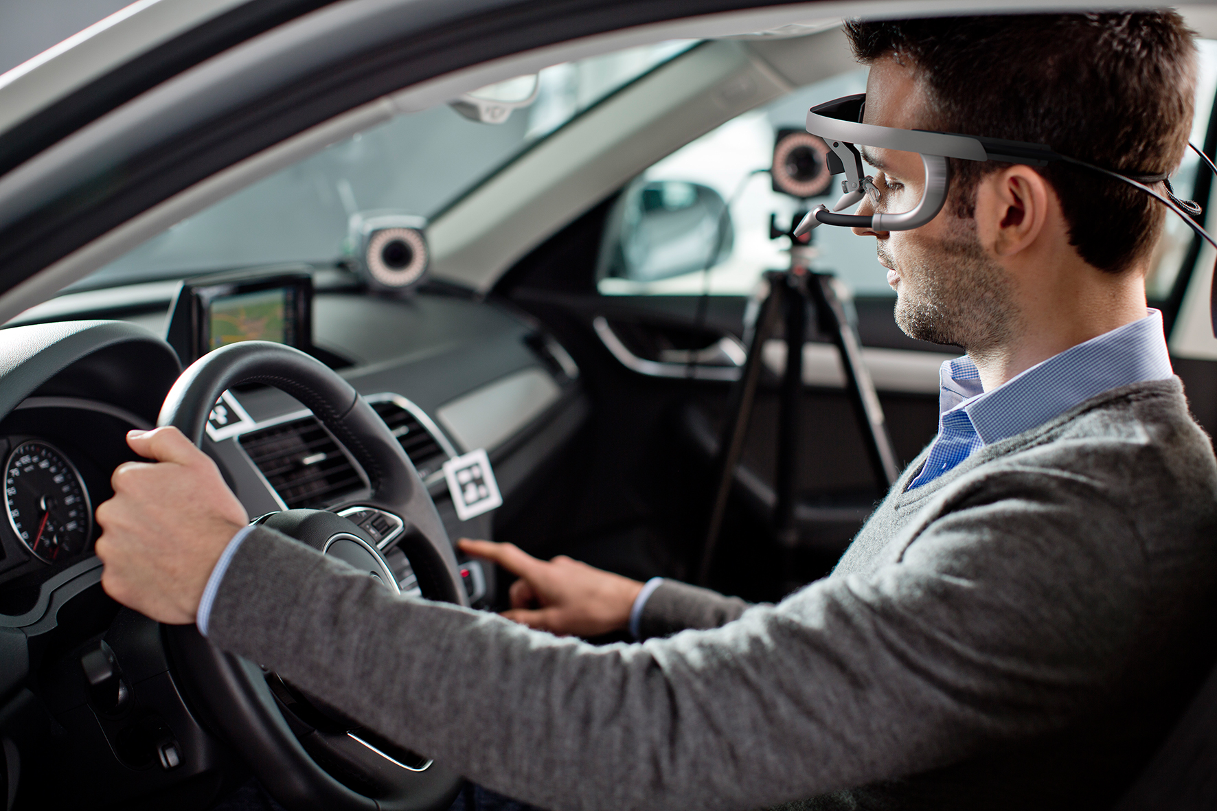 Man in a car wearing eye-tracking glasses